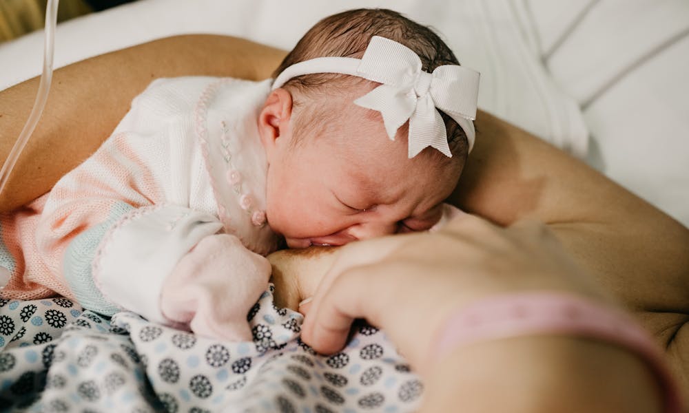 A touching scene of a newborn baby breastfeeding, symbolizing innocence and motherhood.