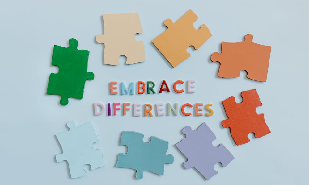 Colorful puzzle pieces surrounding 'embrace differences' text, symbolizing diversity and unity.